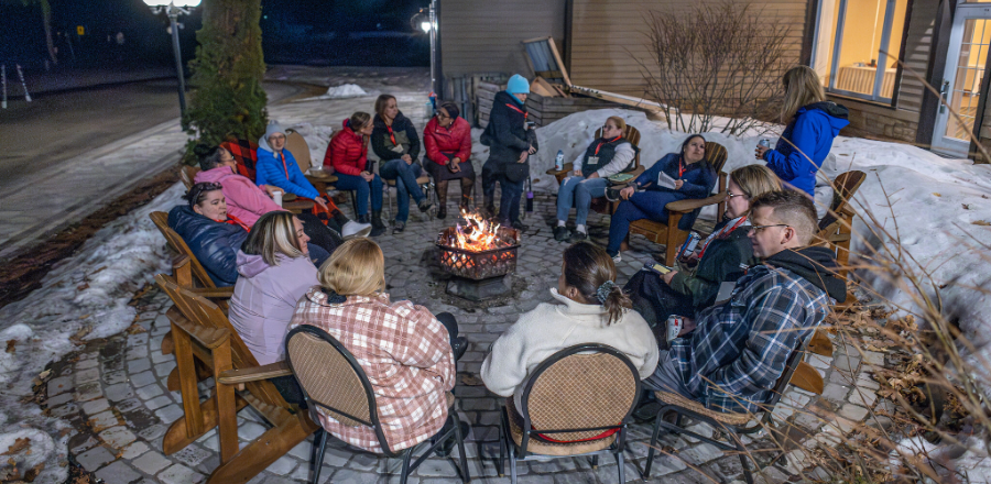 Caregivers and family members of people with neuromuscular disorders gathered around a campfire at Muscular Dystrophy Canada’s Quebec Caregiver Retreat 2025.