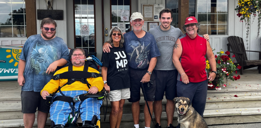 Cathy, her son Daniel, and other friends and family stand outside for a group picture.